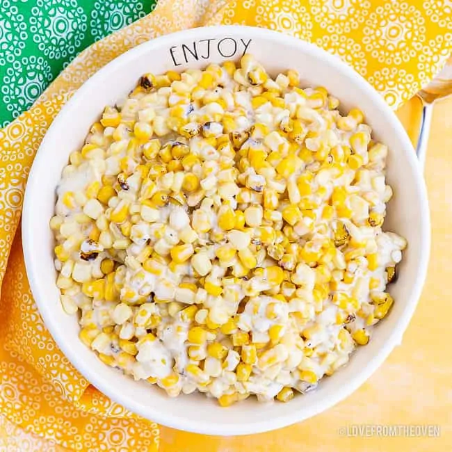 A photo of a large bowl of creamed corn