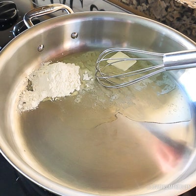 Ingredients for green bean casserole in a stainless steel pan