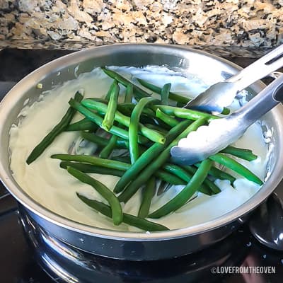 Green beans in a cream base in a stainless steel pan