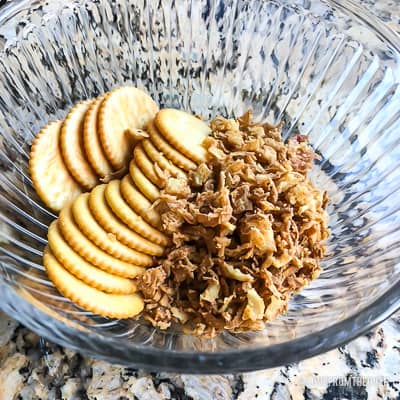 Ingredients for green bean casserole in a glass bowl