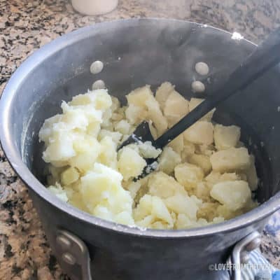 Potatoes being mashed 
