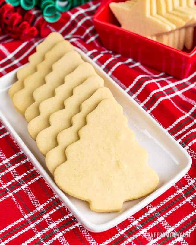 Christmas tree shaped cookies on a white plate with a red napkin