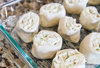 Raw garlic rolls in a glass baking pan