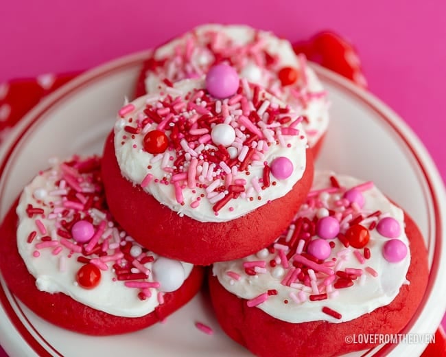 Lofthouse style cookies with sprinkles on a red and white plate