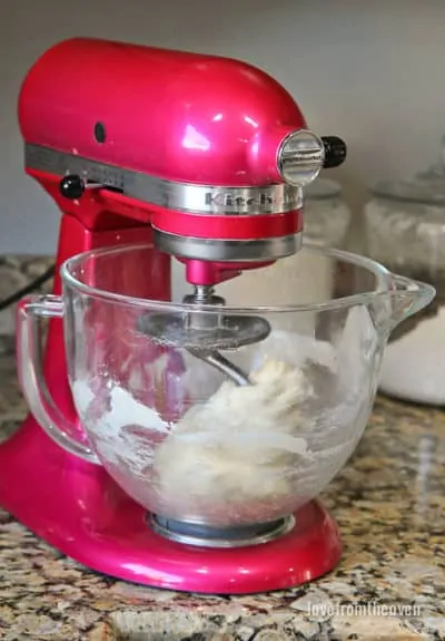 Dough for garlic rolls in a pink stand mixer
