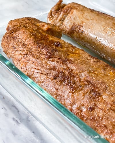 Two pieces of pork tenderloin in glass baking tray