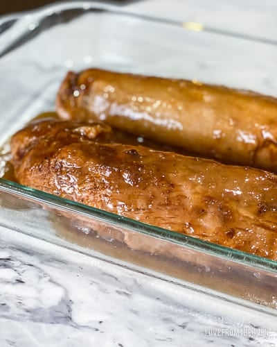 Two pieces of pork tenderloin in glass baking pan