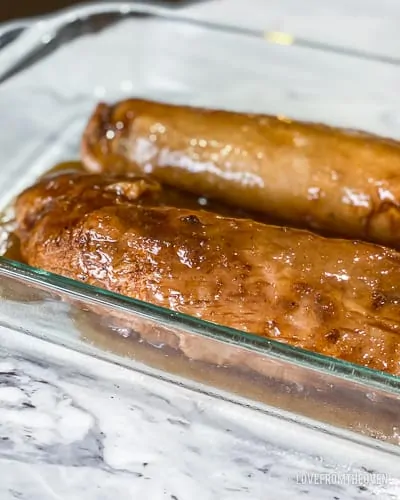 Two pieces of pork tenderloin in glass baking pan