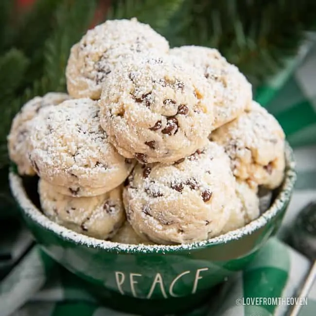 Pile of snowball cookies in a green bowl