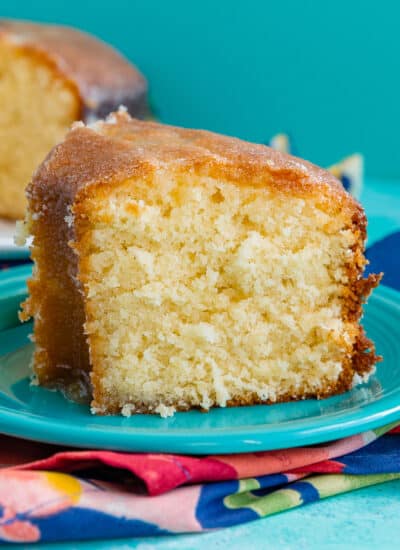 A slice of Kentucky butter cake on a blue plate.