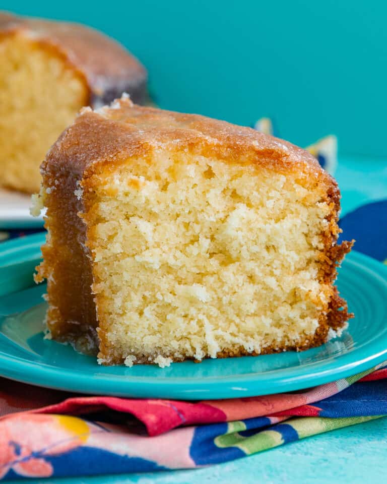 A slice of Kentucky butter cake on a blue plate.