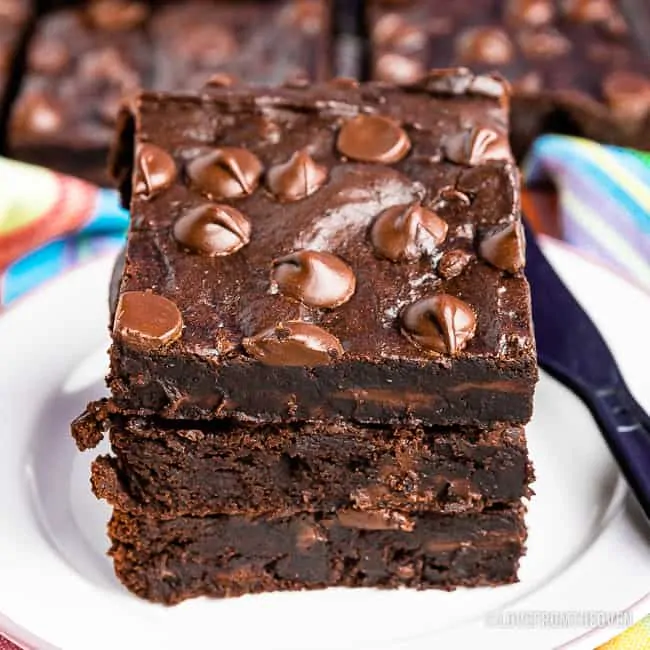 Stack of three black bean brownies on a plate