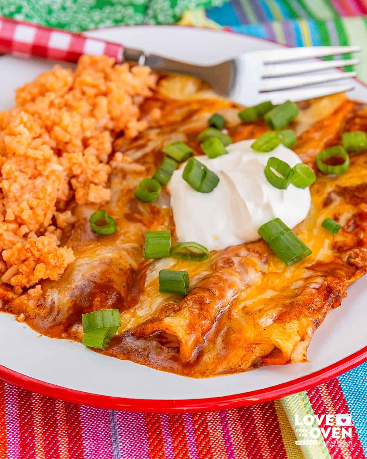 A plate with cheese enchiladas and mexican rice