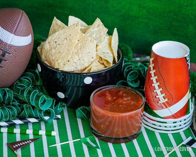 Bowl of tortilla chips next to small bowl of salsa