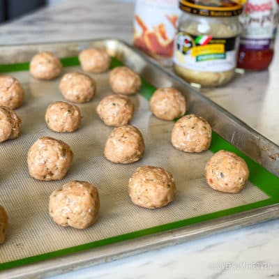 Chicken parm meatballs on a baking sheet