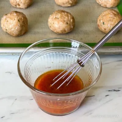 Small bowl with sauce for chicken parm meatballs