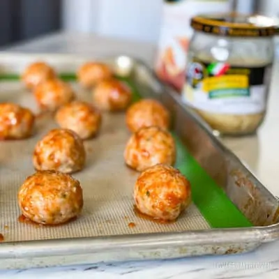 Chicken parm meatballs on baking sheet
