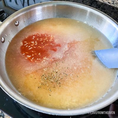 Ingredients for Mexican rice in stainless steel pan