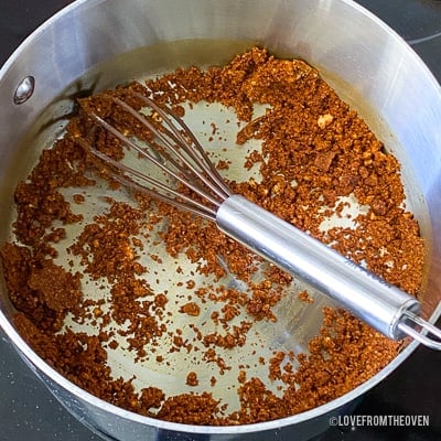 Raw ingredients for enchilada sauce in stainless steel pot