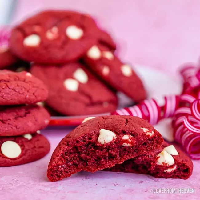 Several red velvet cookies with one broken in half