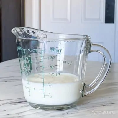 A measuring cup full of milk