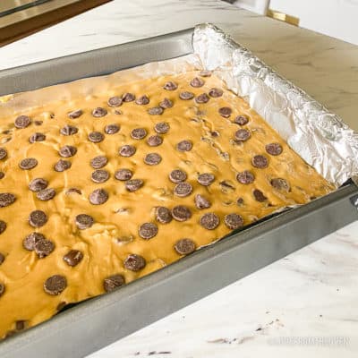 chocolate chip cookie bar batter in a pan