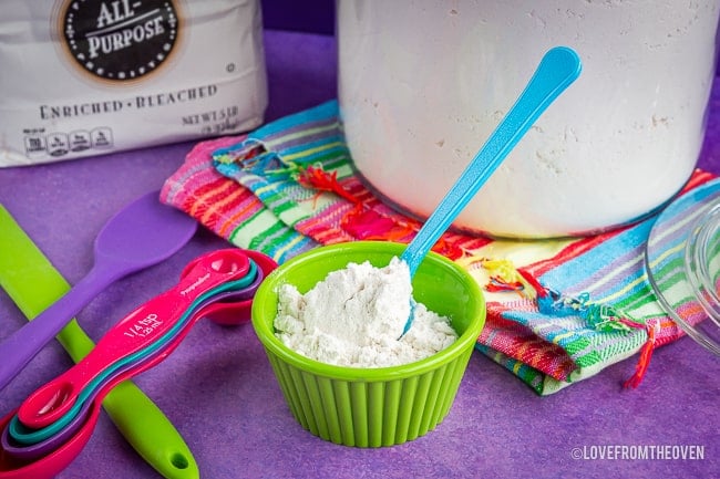 A cup of flour on a table