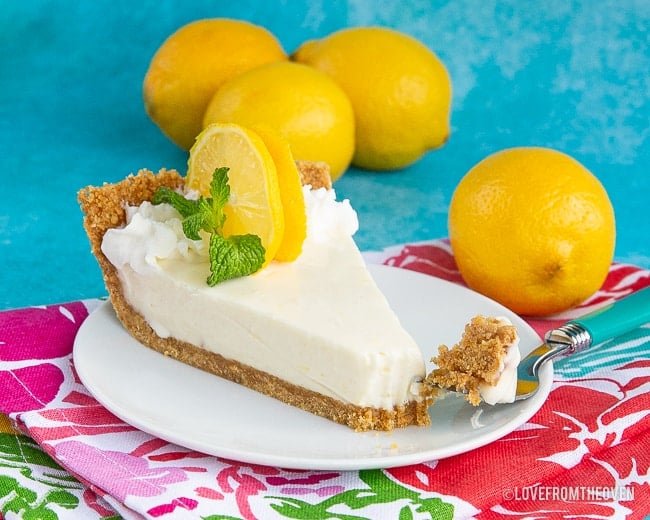 A pie with lemons on a plate