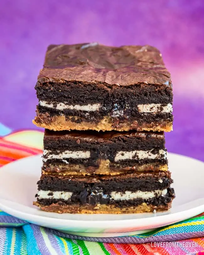 Three brownies stacked on a plate