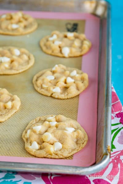 A tray of food on a table, with white Chocolate chip cookies