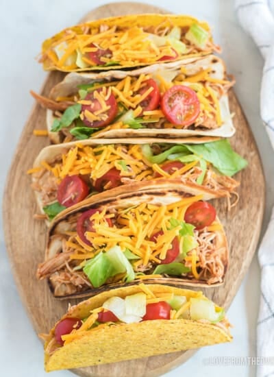 Plate full of chicken tacos on a white background