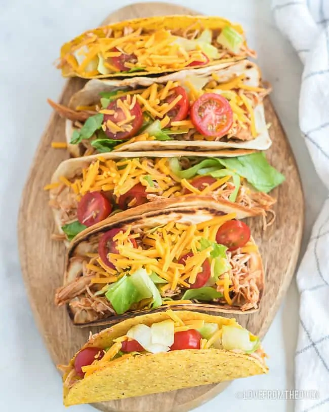 Plate full of chicken tacos on a white background