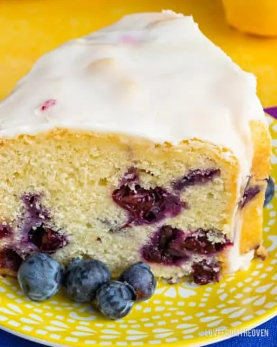 A piece of cake on a plate, with Lemon and Blueberry