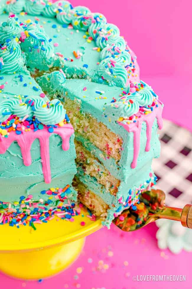 A funfetti cake being sliced