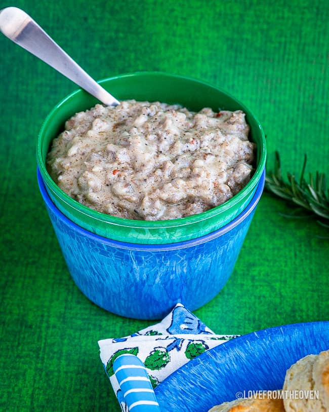 A bowl of food sitting on a table, with Gravy 