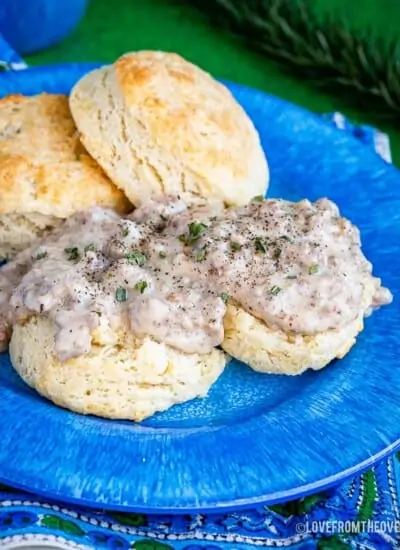 Food on a blue plate, with Gravy and Biscuit