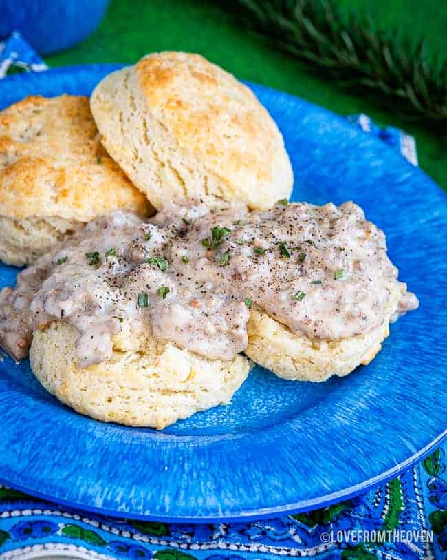 Food on a blue plate, with Gravy and Biscuit