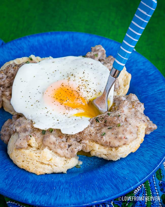 Food on a blue plate, with Gravy and Biscuit