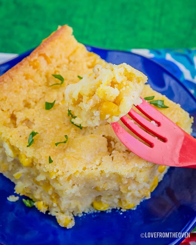 Plate of Jiffy Corn Casserole on a green background