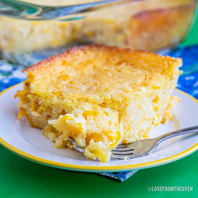 Slice of Jiffy Cornbread Casserole on a white plate with a fork