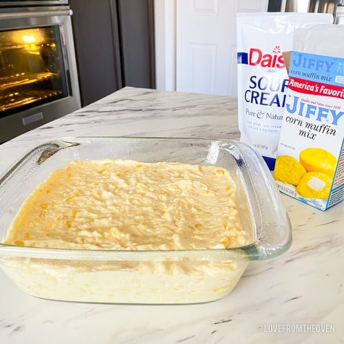 Corn casserole in a square baking dish prior to baking