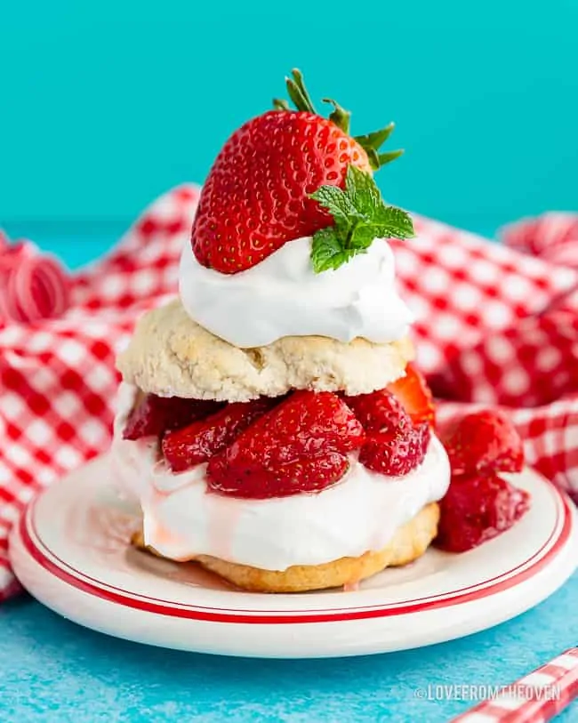 Bisquick strawberry shortcake on a plate with a blue background and red and white napkin