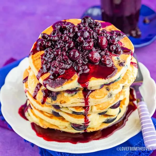 Stack of blueberry pancakes topped with blueberry topping