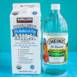 A carton of milk and a bottle of vinegar to make homemade buttermilk