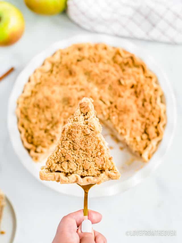 A slice of Dutch apple pie cut out of a pie