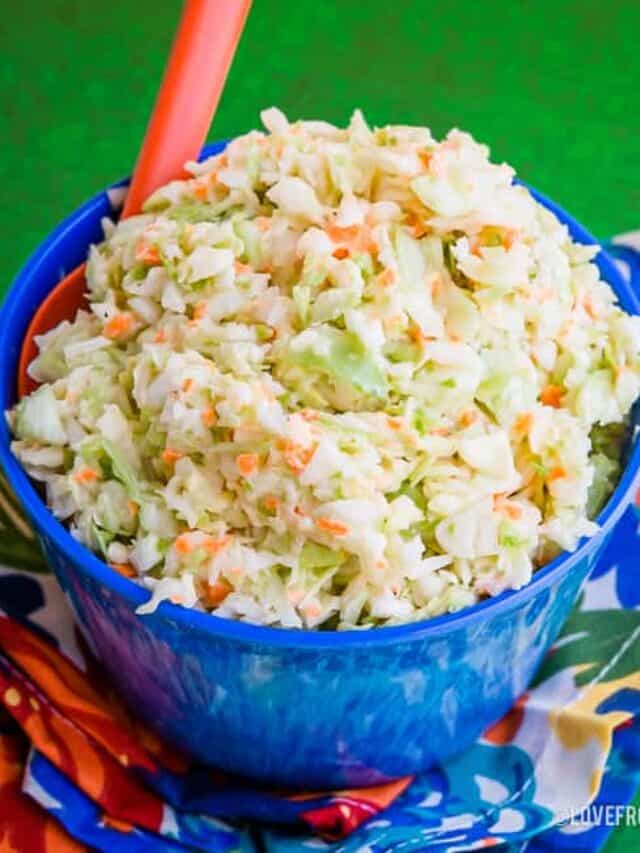 Bowl of KFC Copycat Coleslaw on a green background