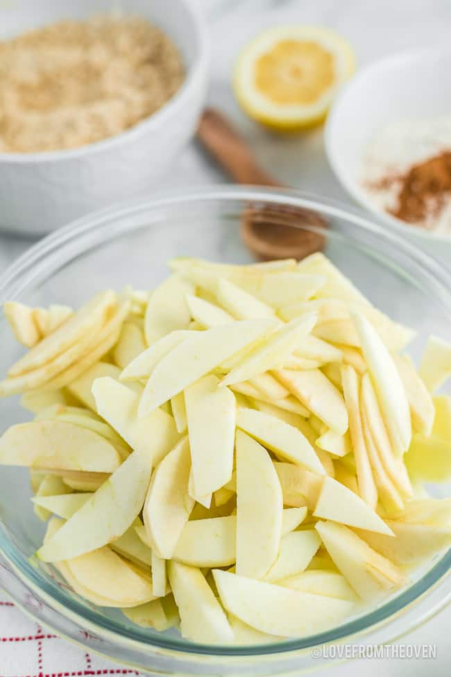 Apples peeled and sliced in a glass bowl