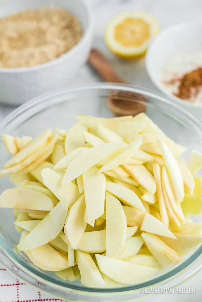 Apples peeled and sliced in a glass bowl