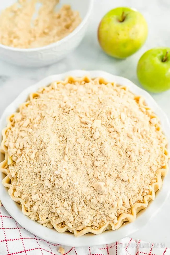 Apple pie with crumb topping prior to baking