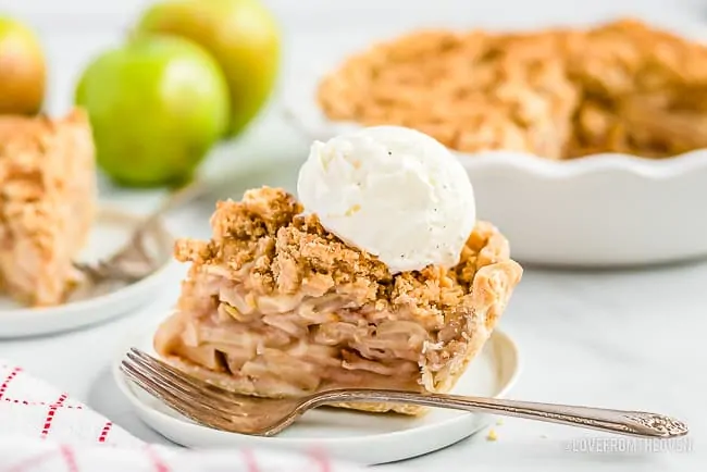 A slice of Dutch apple pie topped with ice cream 